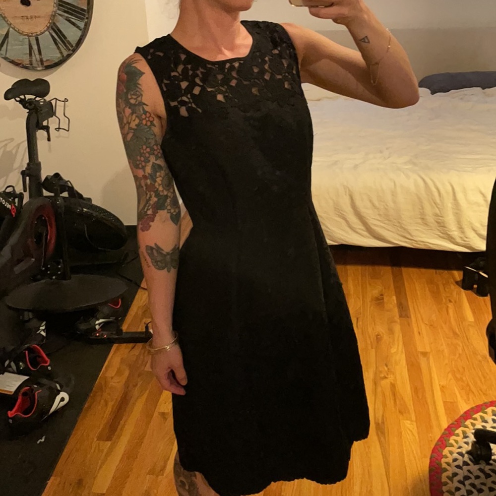 Black sleeveless dress. Adorable floral detail.
